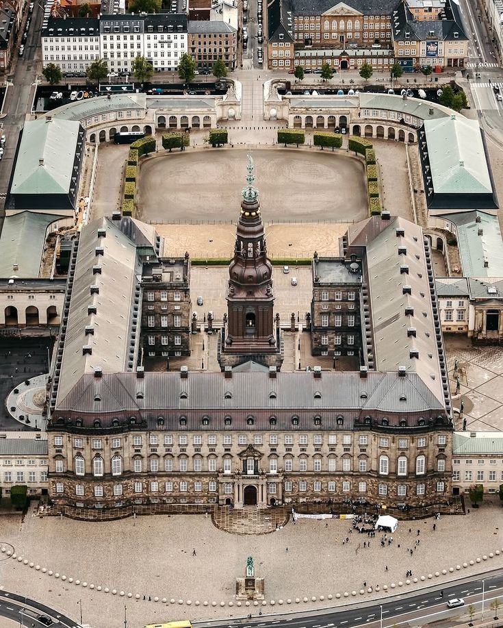 Ornate historic building with a tall tower and statue.