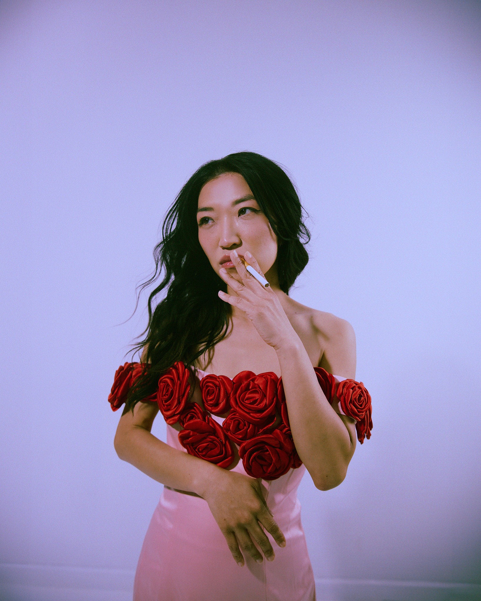 Woman with red hair covering mouth with hair