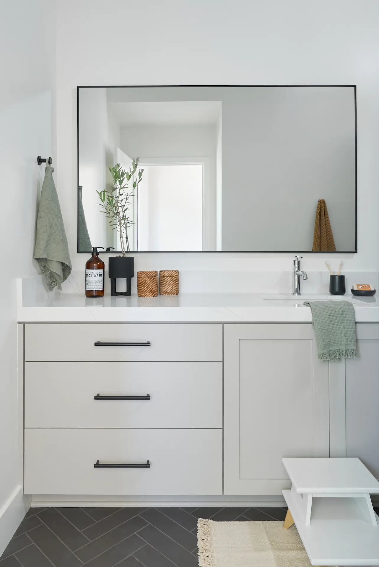 Close-up of the sink area and fixtures in the kids' bathroom. Photo by Todd Huge.