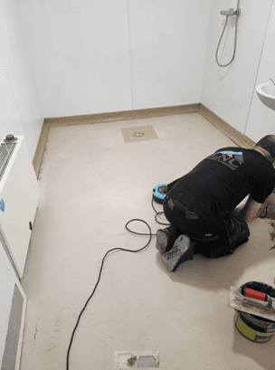 a person using a screwdriver on a piece of wood