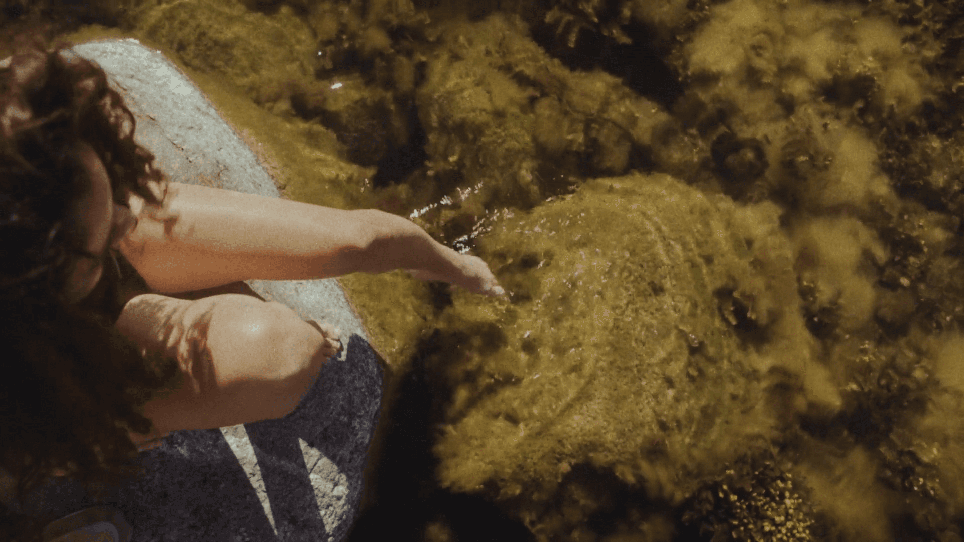 A person walks down a dimly lit alley at night.