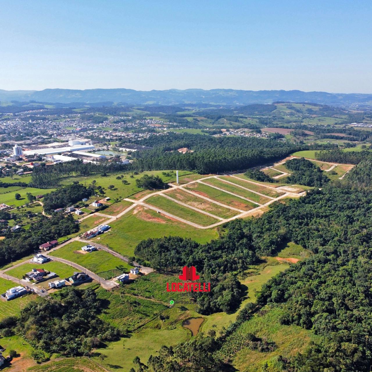 A modern brick house with a two-car garage, well-manicured lawn, and clear blue sky in the background.
