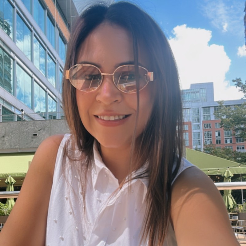 woman in white button up shirt smiling