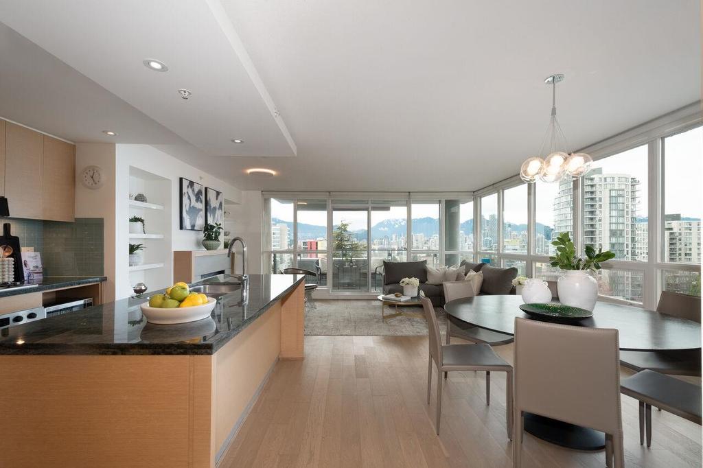 Spacious modern living area with large windows, light-colored walls, and stylish furniture.