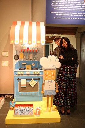 student posing next to made up stove