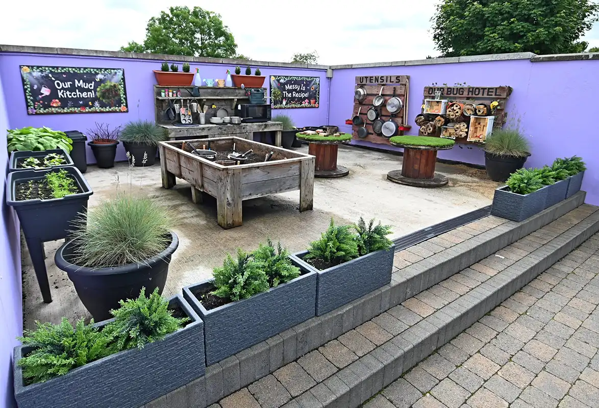 Vibrant children's play area with colorful toys, slides, and building blocks on artificial turf