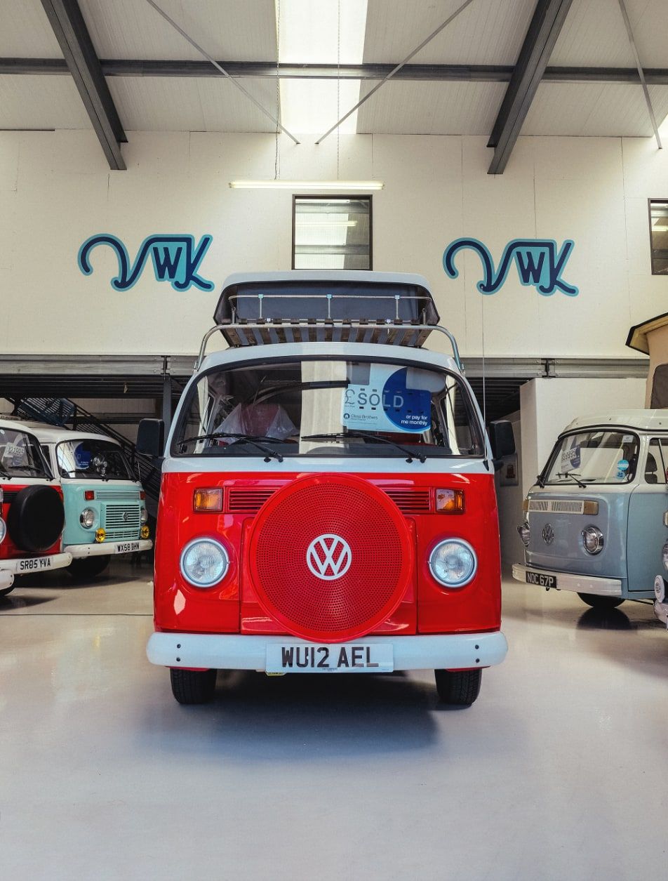 Camper van warehouse with VW Kampers signage in the background