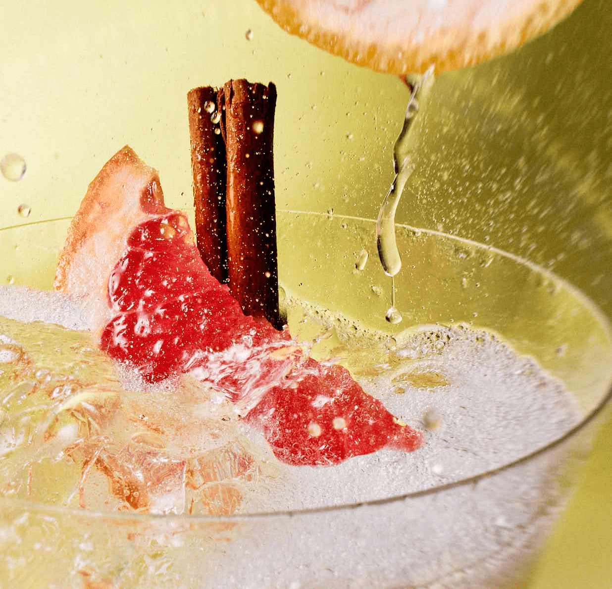 Refreshing grapefruit cocktail with cinnamon sticks and lime juice.