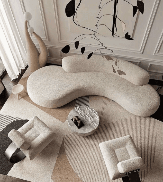 Overhead view of a curved sofa and sculptural interior composition for design vision planning.