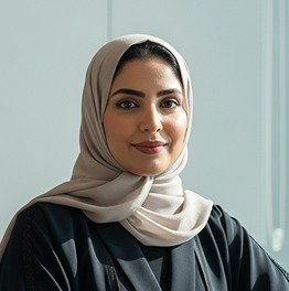 smiling woman wearing white and black pinstriped collared top