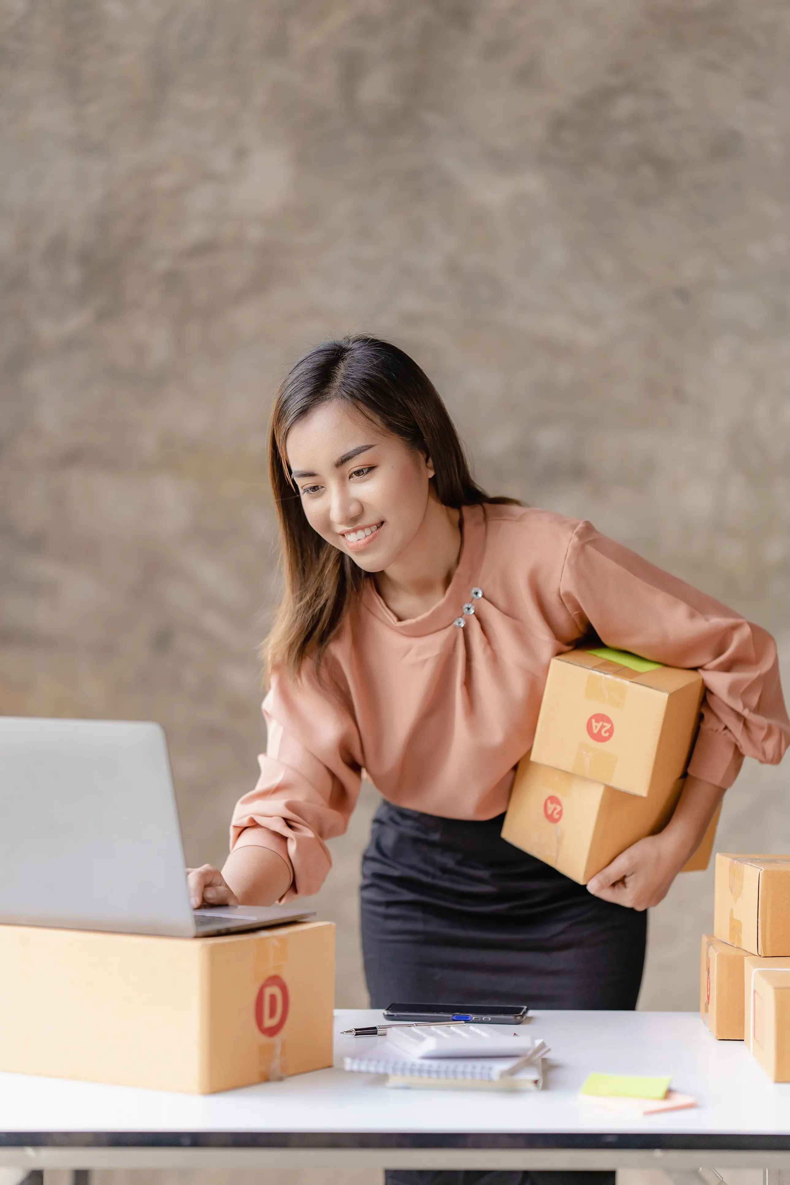 Person marking boxes for dropshipping
