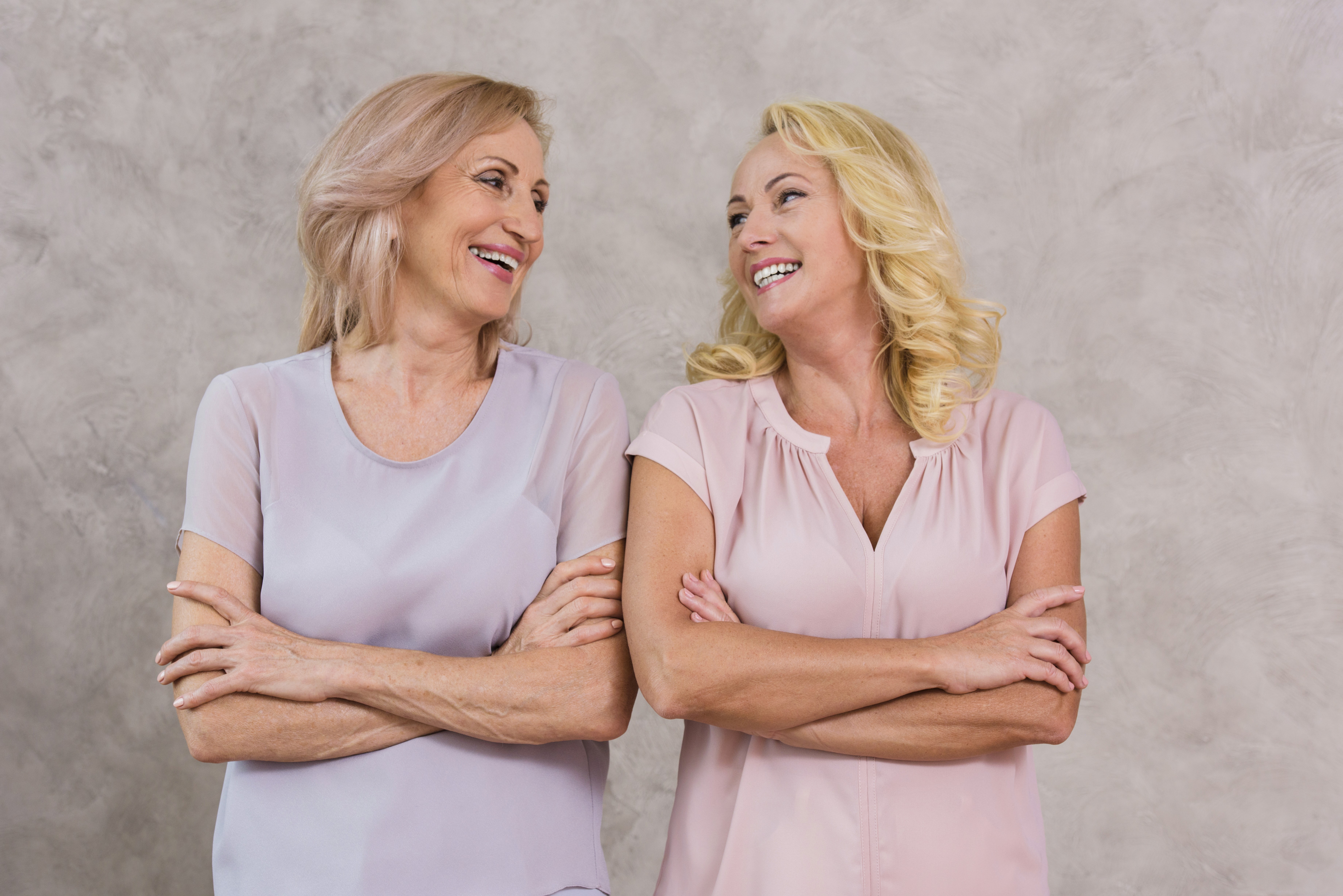Two adult women smiling at each other
