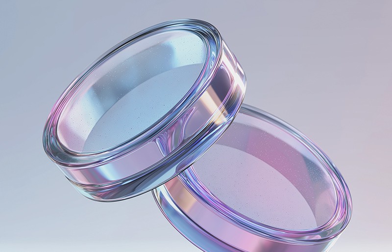 Two abstract rings stacked on top of one another on a light colored background