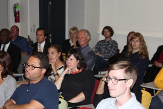 people sitting on chair in a room at a presentation