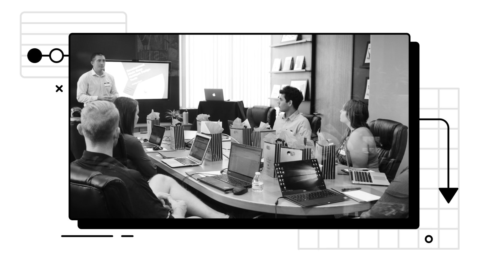 Photo of a group of people paying attention to someone speaking in a room.