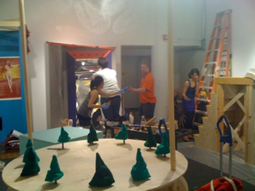 student preparing installations for The Candy Coated Carnival of Controversy