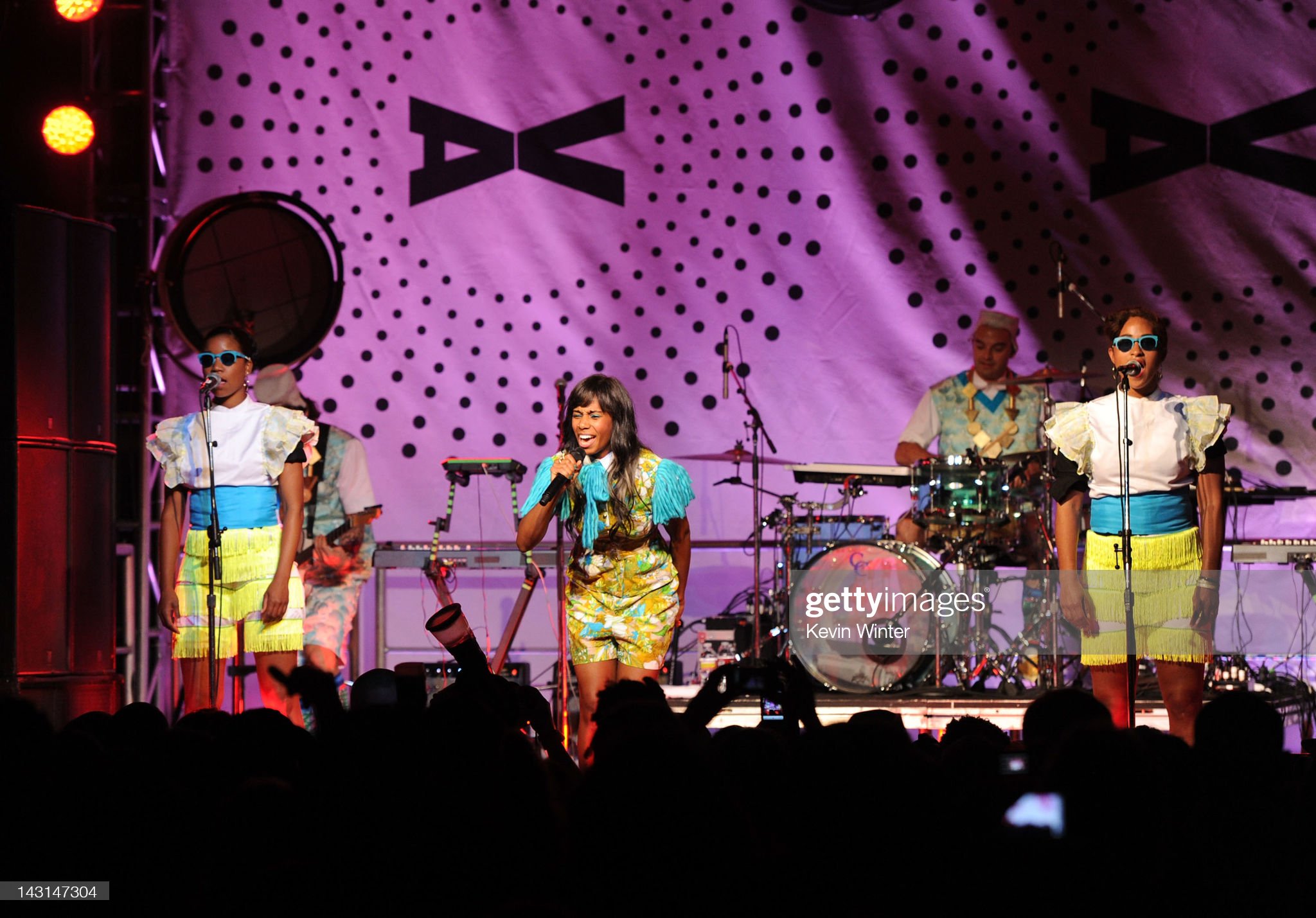 Santigold in front of backdrop