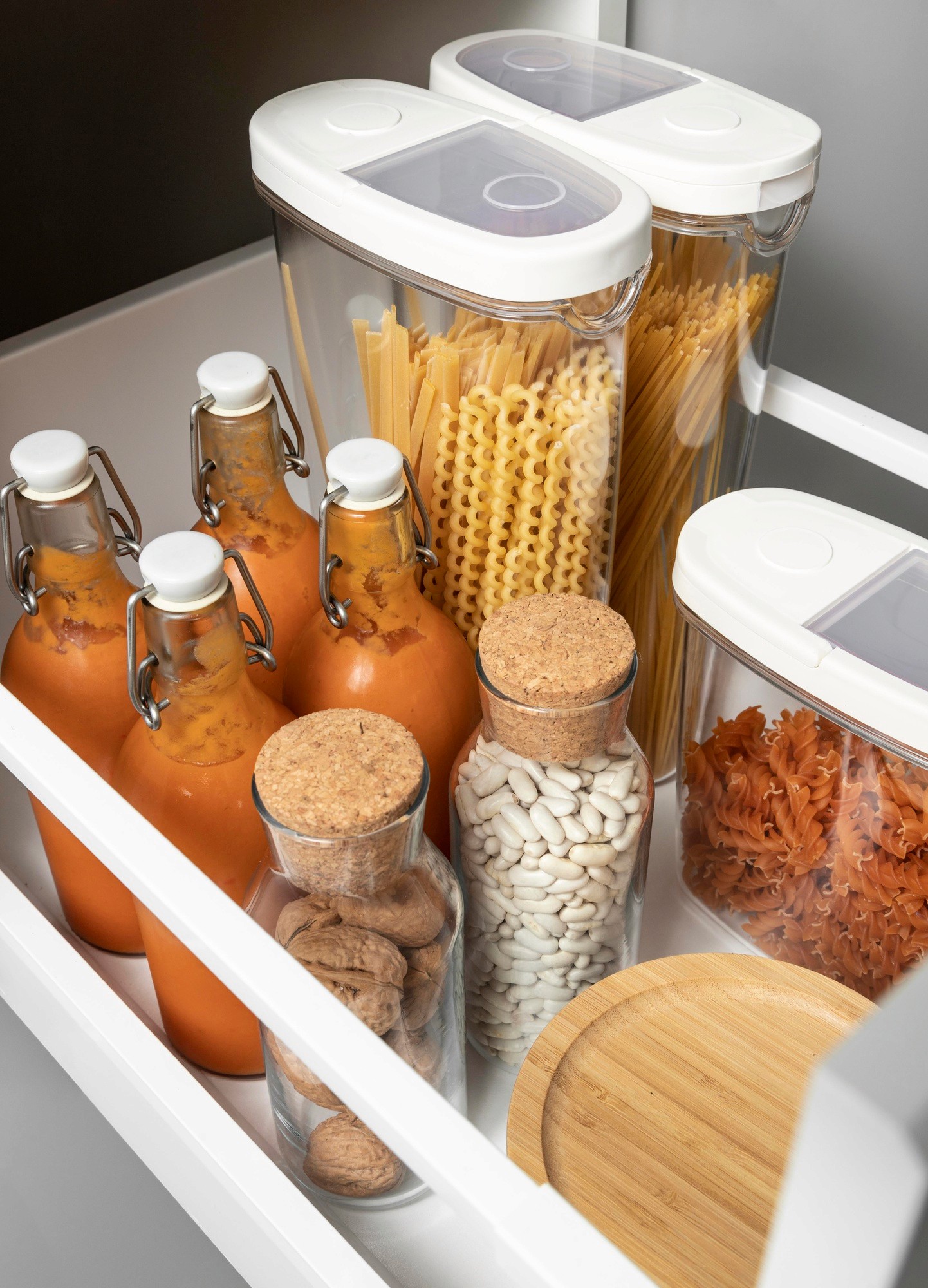 A pull-out pantry next to a refrigerator, showcasing organized storage