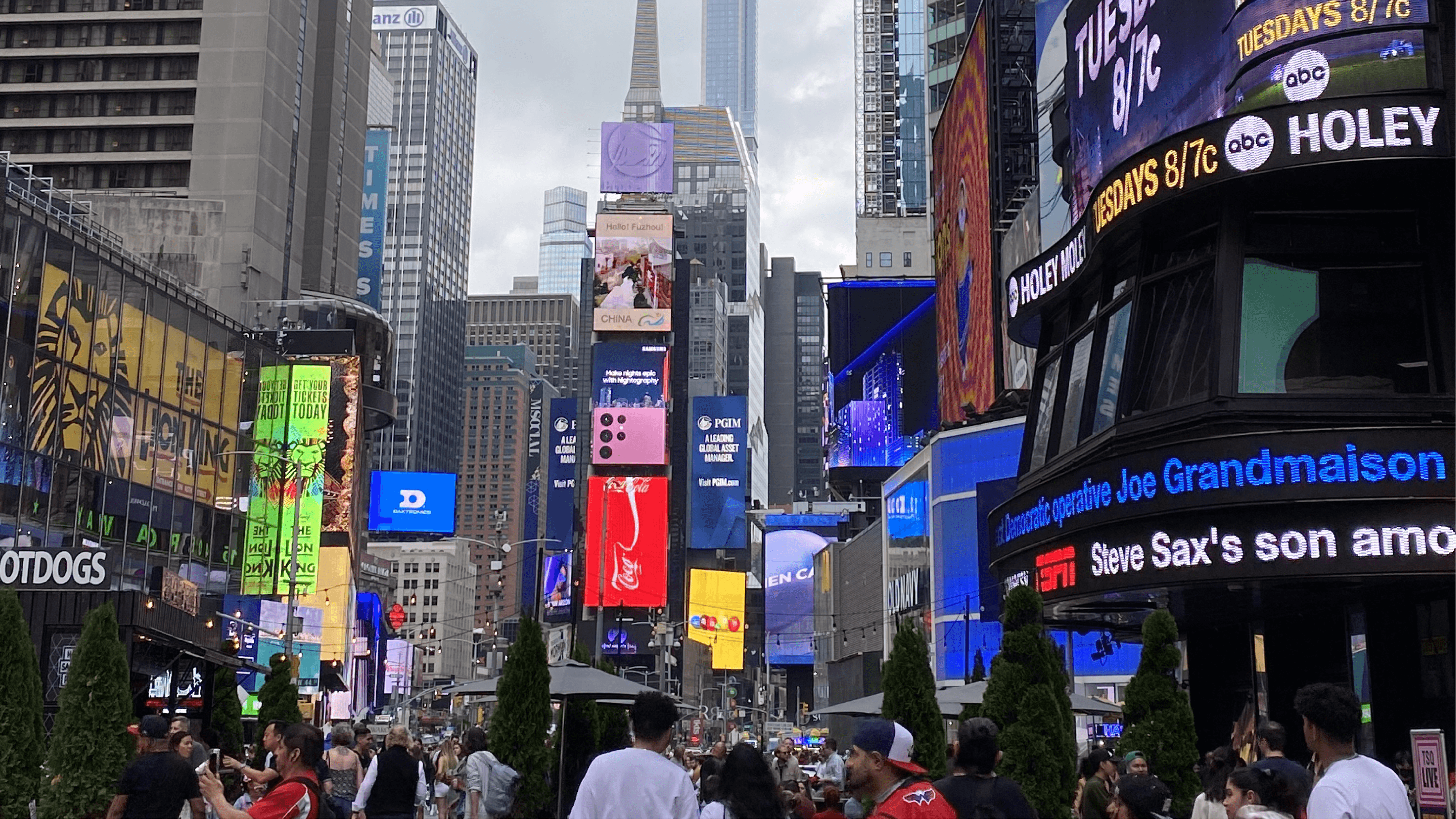 Times Square street scene filled with digital billboards, signage, and dense urban typography in New York City.