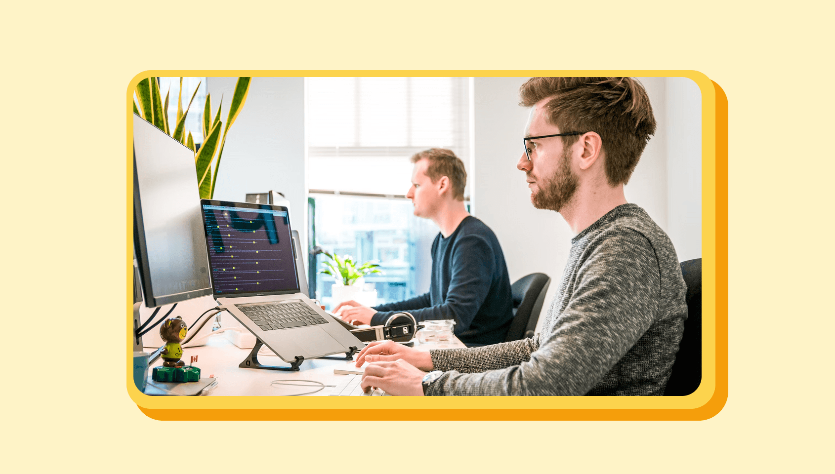 A couple of customer support people working on the support requests.