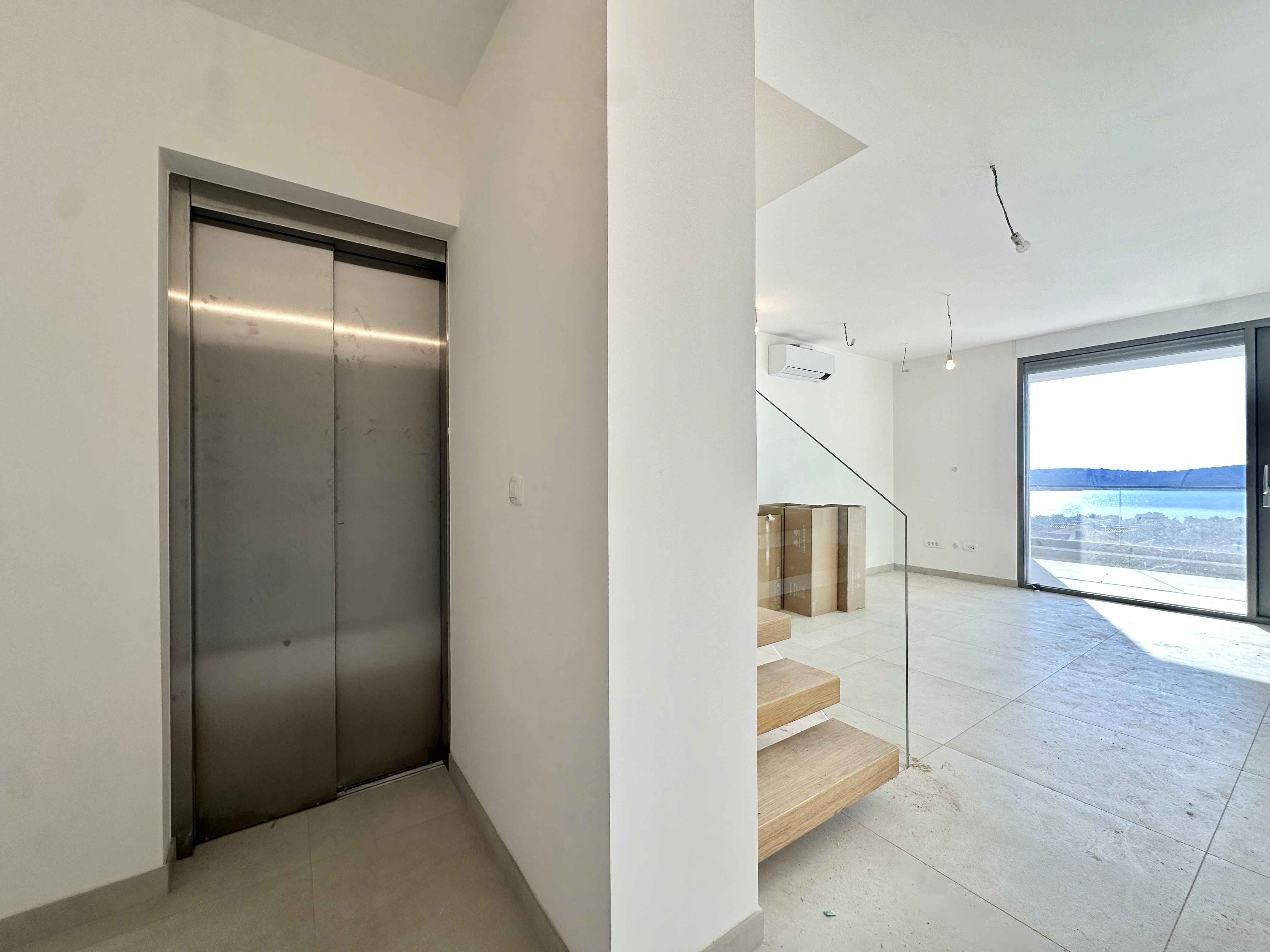 Bedroom with wall bookshelf and mountain view.
