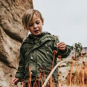 Young boy hiking through the hills our Denver, Colorado. 