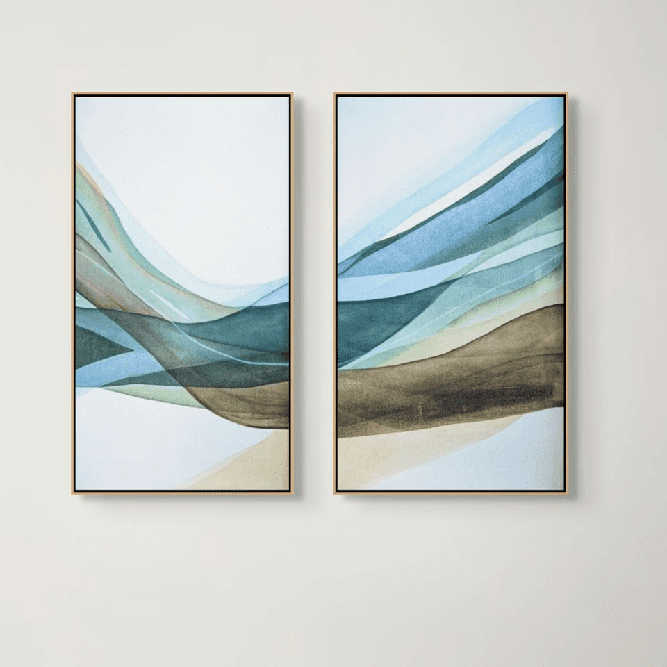 Abstract artwork featuring two framed pieces with wavy lines in shades of blue, green, and beige on a white wall.