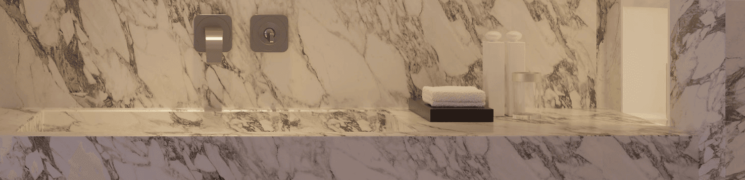 Marble bathroom features built-in tub and toiletries.