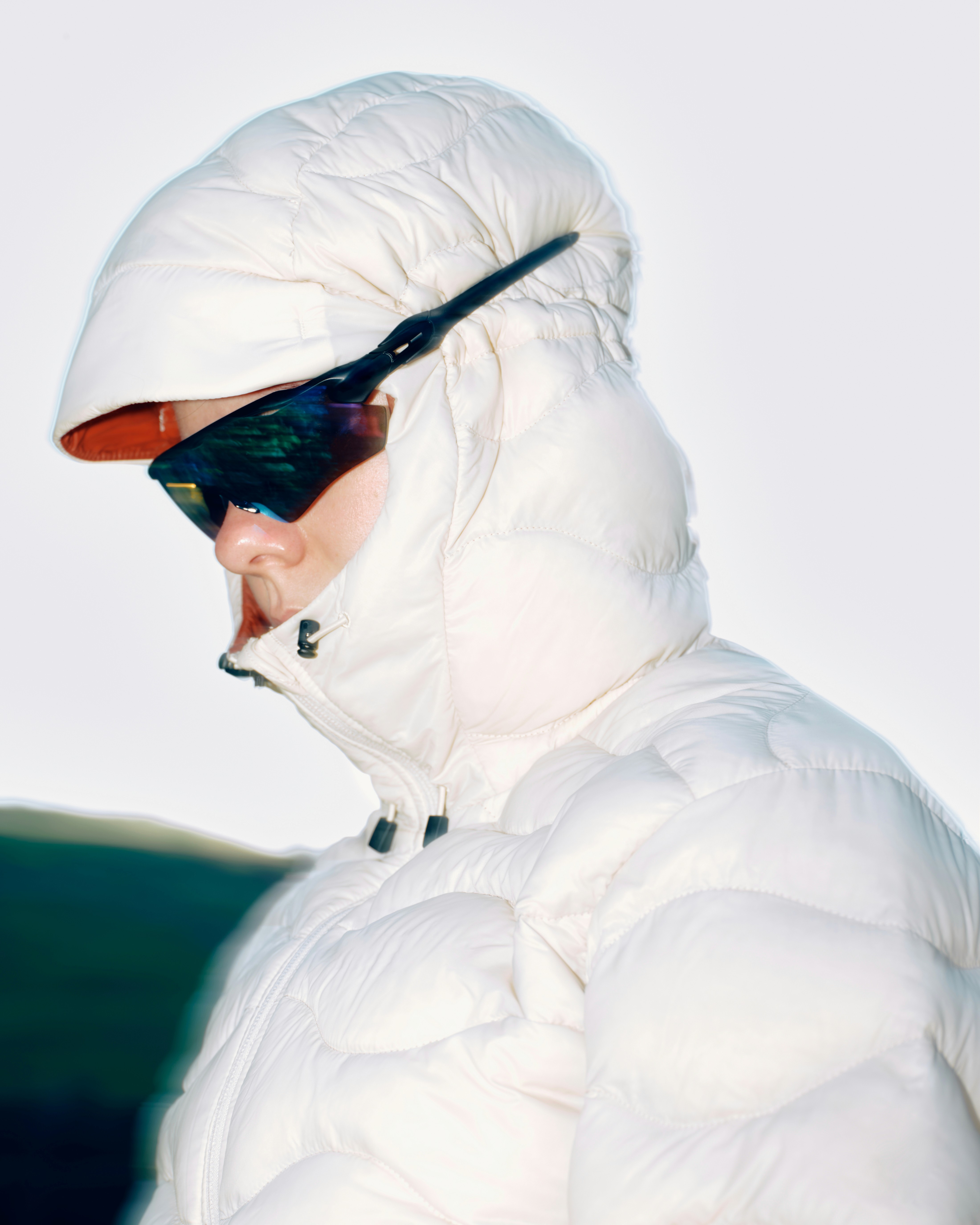 person with white puffer jacket and sunglasses