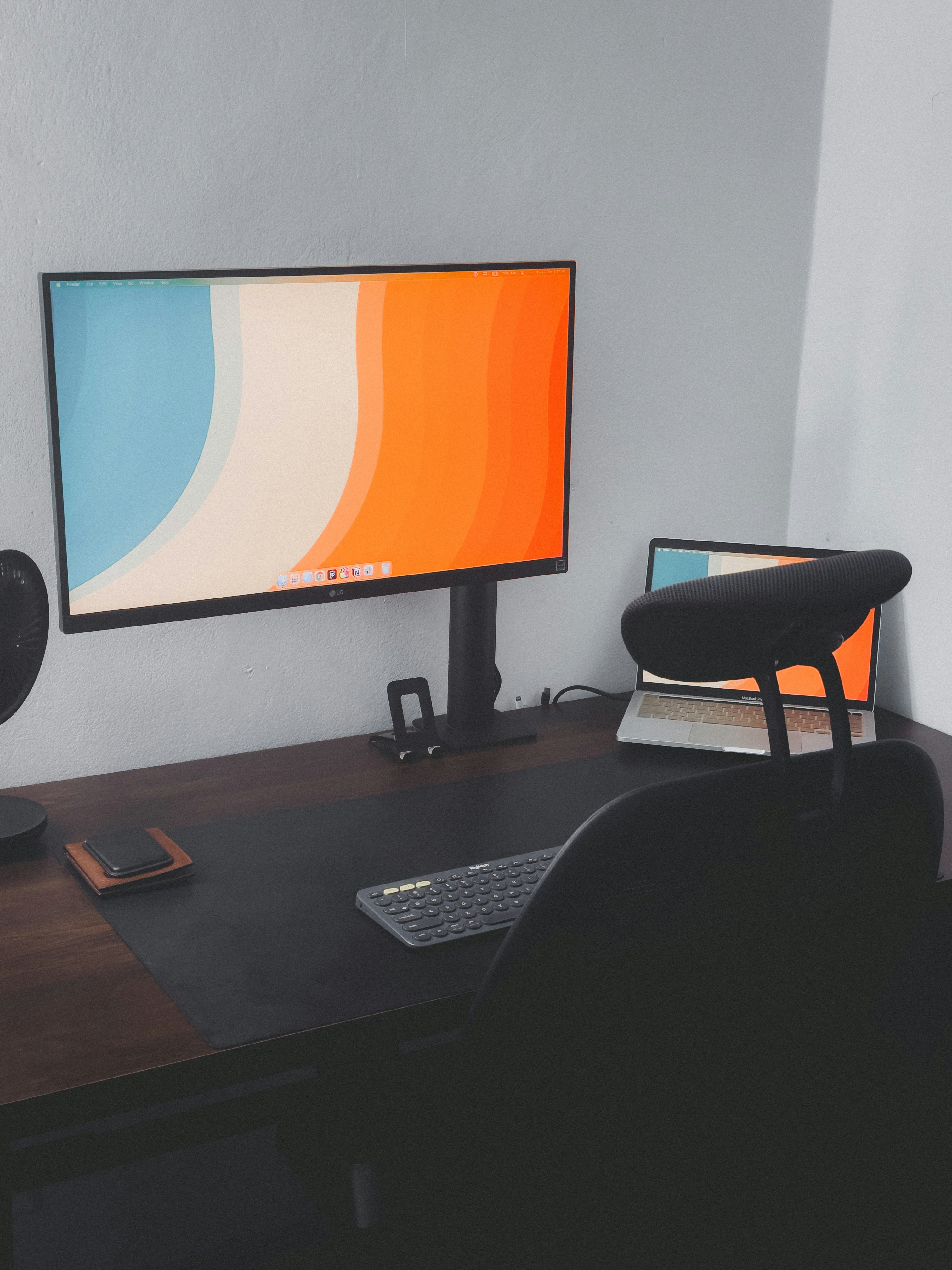a computer monitor sitting on top of a wooden desk