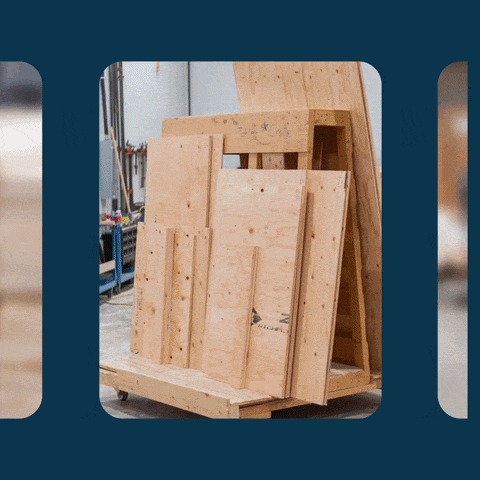 Stacked plywood crate panels on a workshop trolley