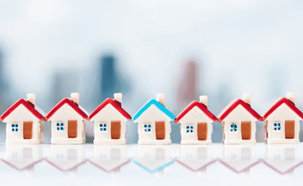 Row of miniature houses with red and blue roofs