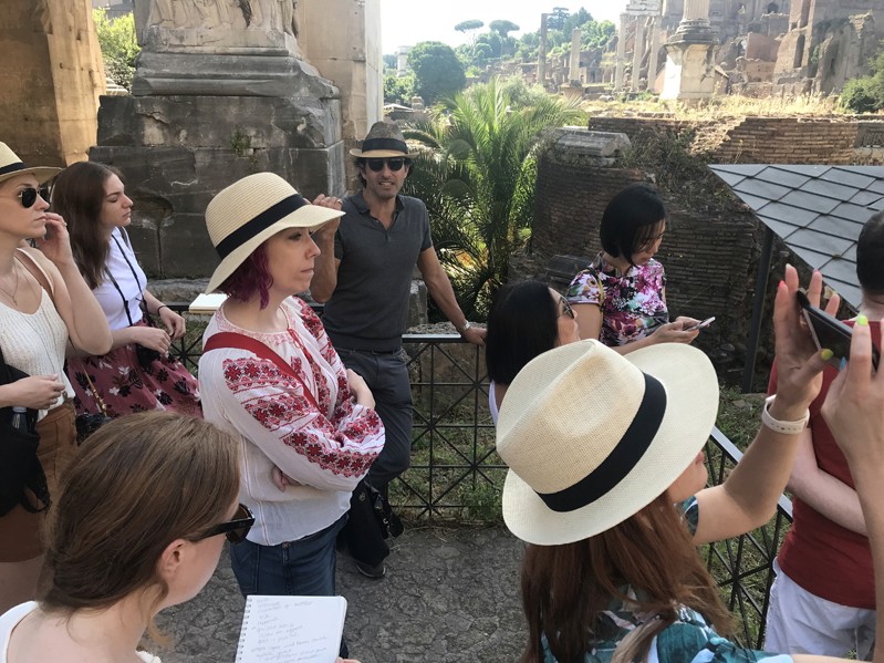 A photo of a group of people visiting some ancient ruins in Rome.