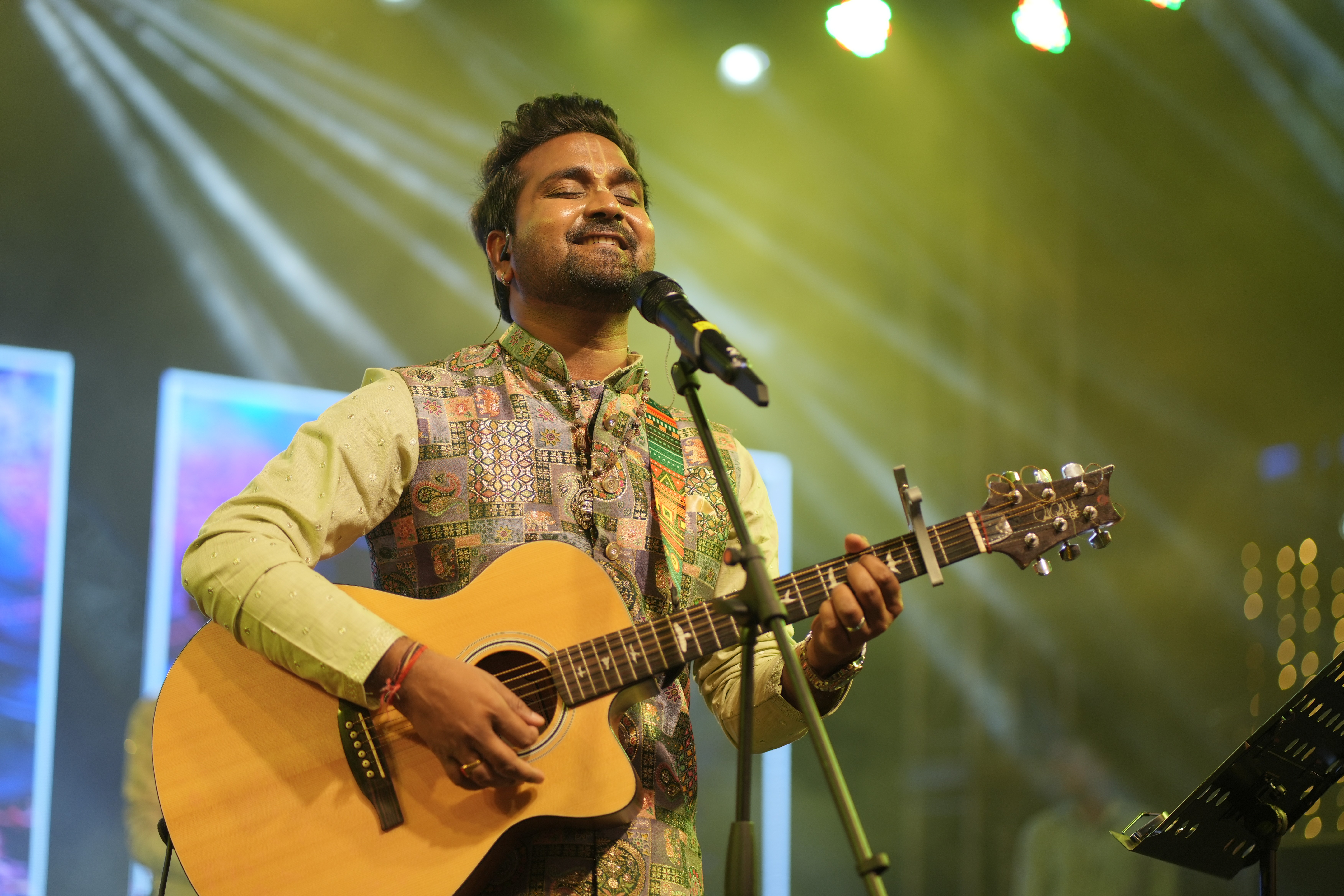 Large crowd at concert with bright lights