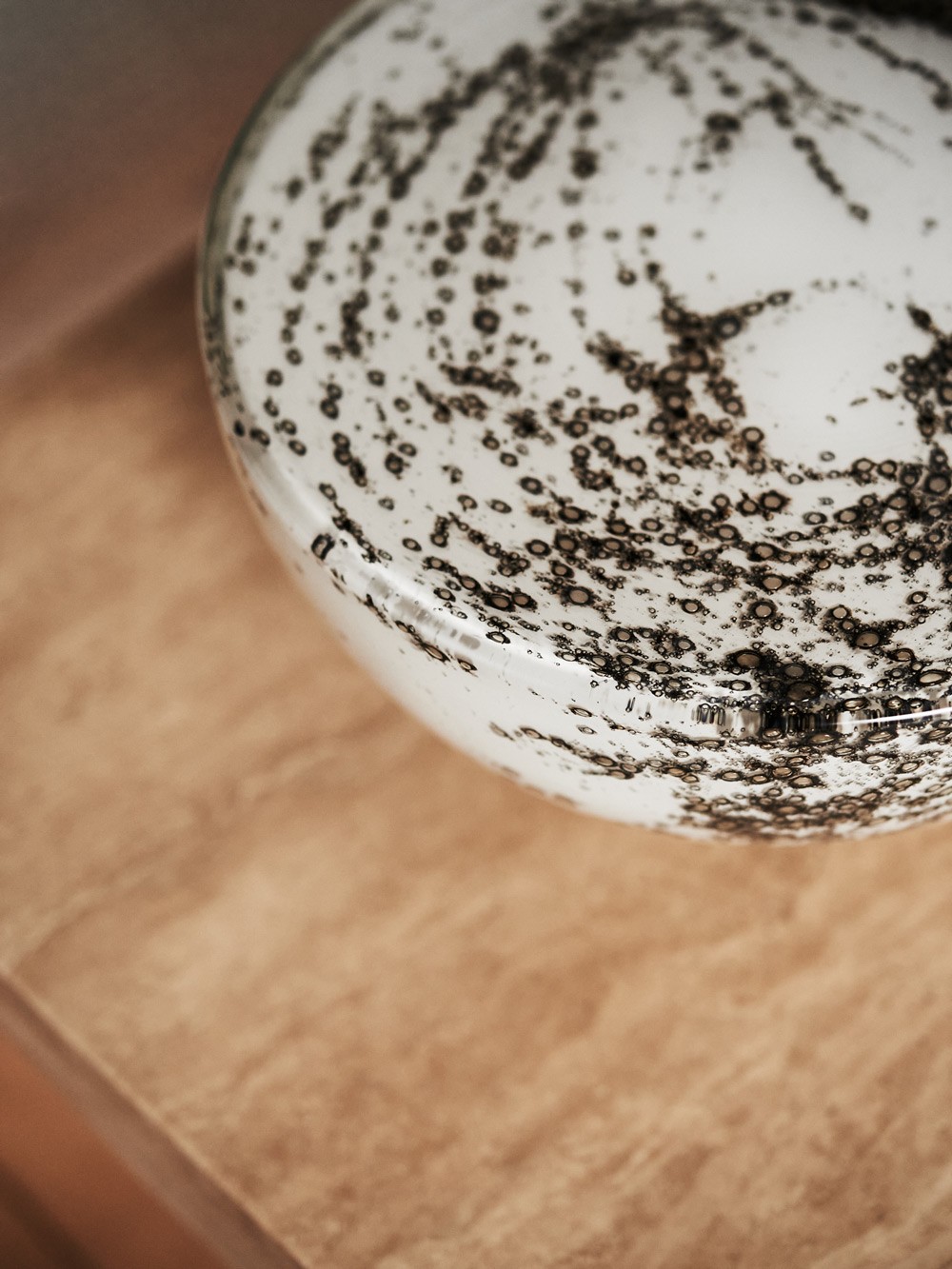 Orla table lamp close up– flat-faced glass with volcanic frit patterning