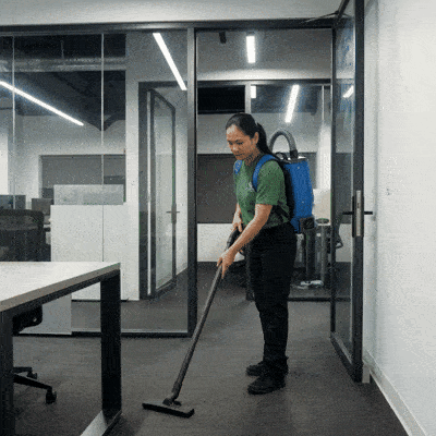 No Spots staff cleaning a mirror