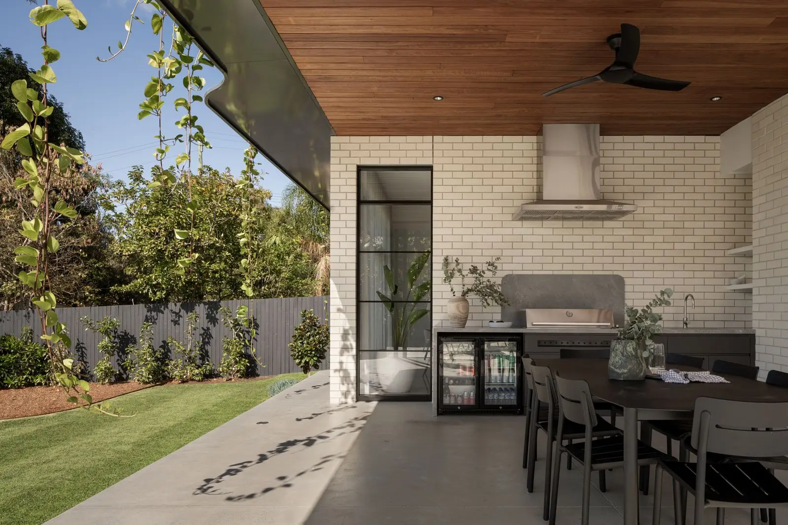 Outdoor entertainment area with a fully equipped outdoor kitchen and glass front fridge