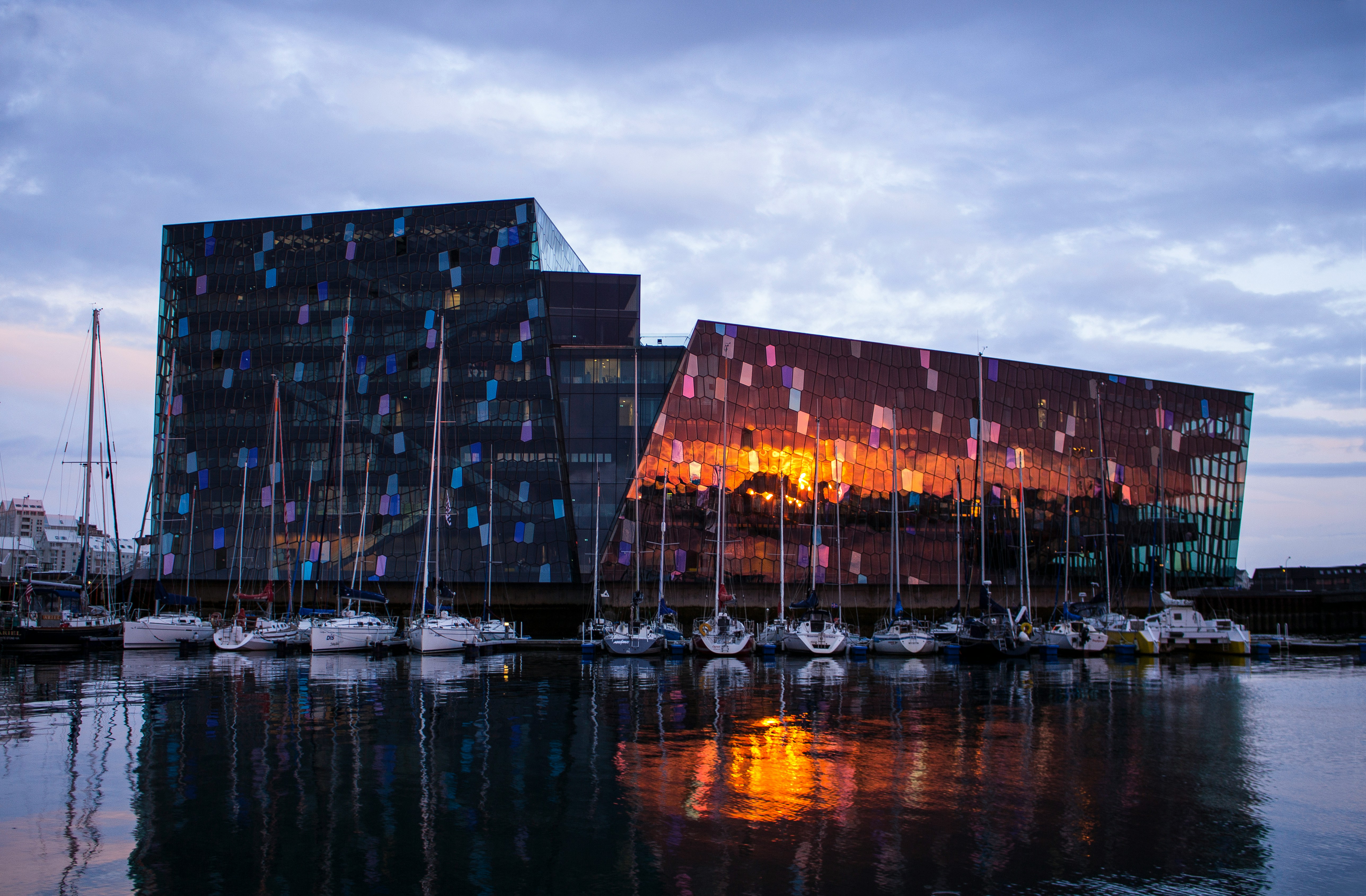 Sunset reflecting on the glass façade of Harpa Concert Hall.