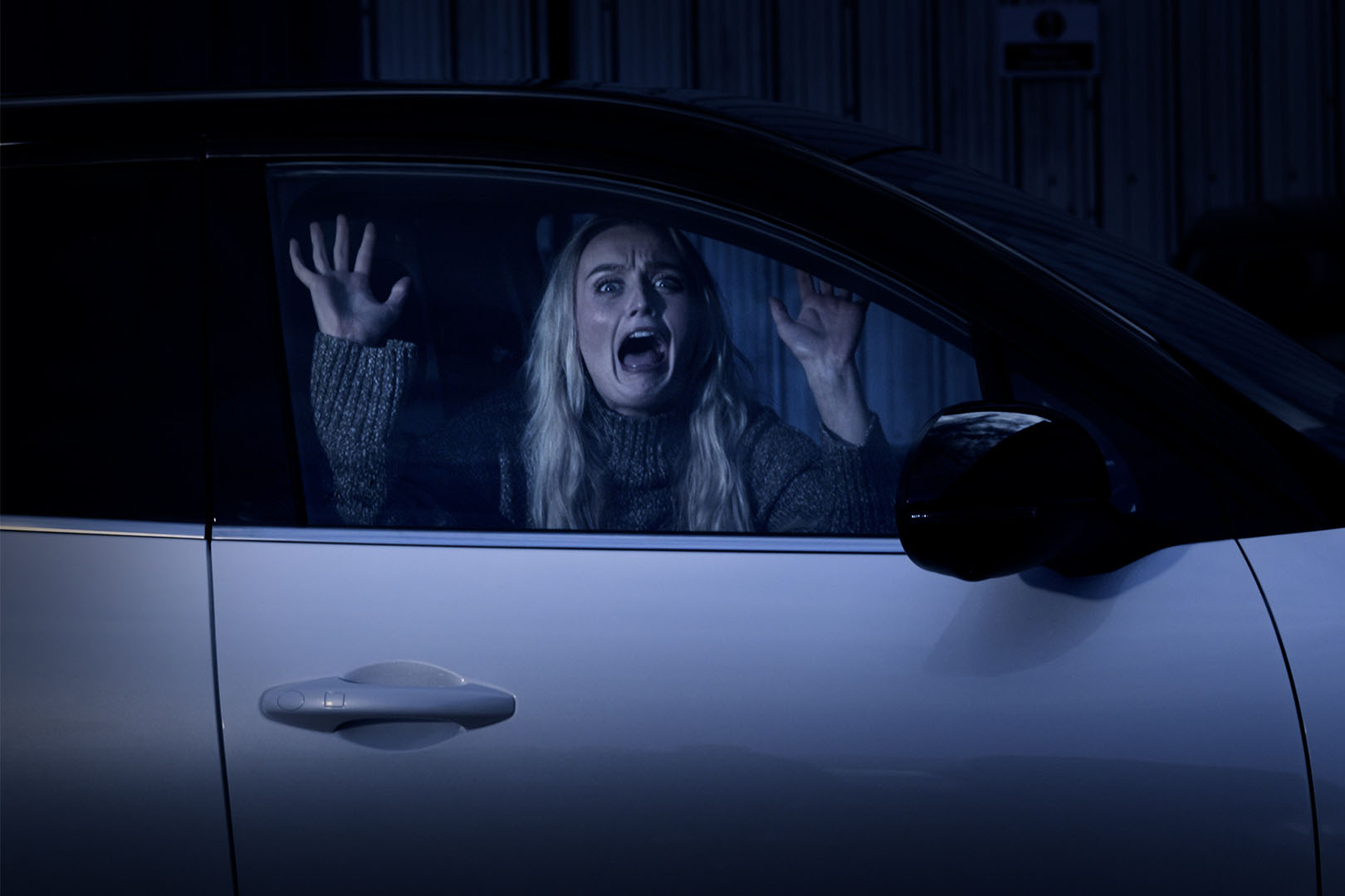 A woman inside a car screaming