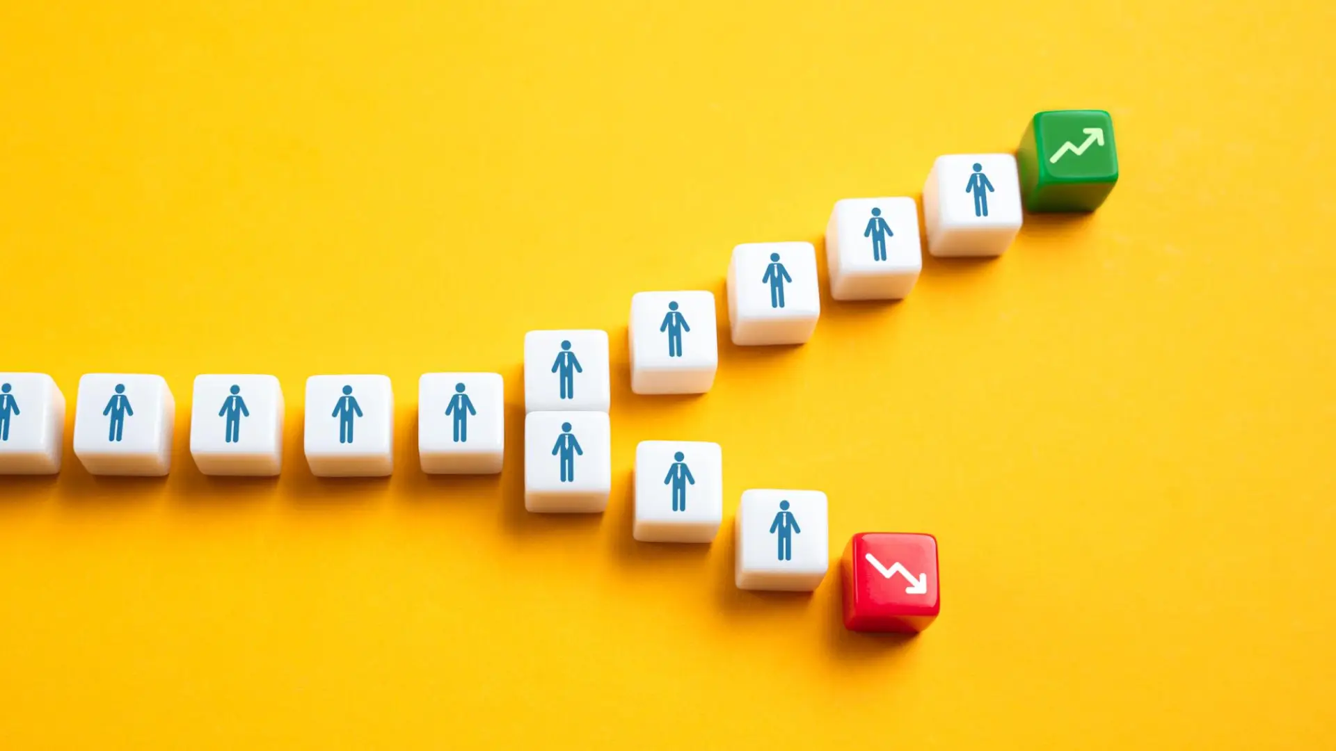 White blocks with person icons showing two paths, one leading to growth, the other to decline, representing sales conversion.