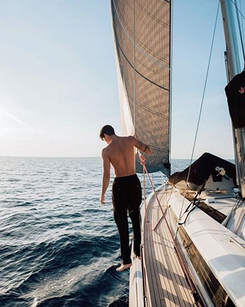Muscular man on a sailboat