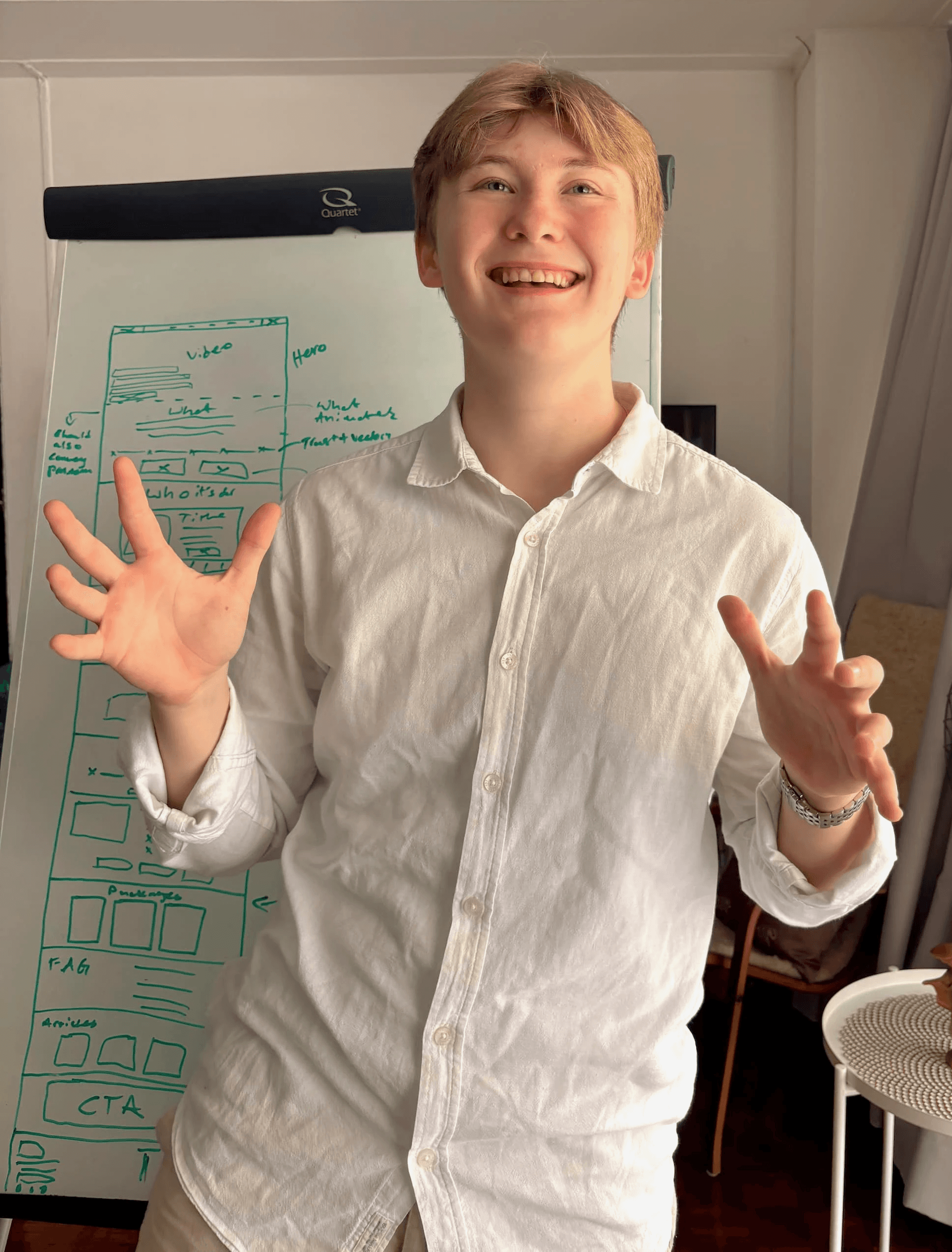 Image of Noah Frummerin smiling talking through the layout plan of Chetna Chudasamas website.