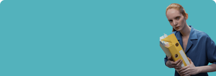 Healthcare worker holding folders against blue background.