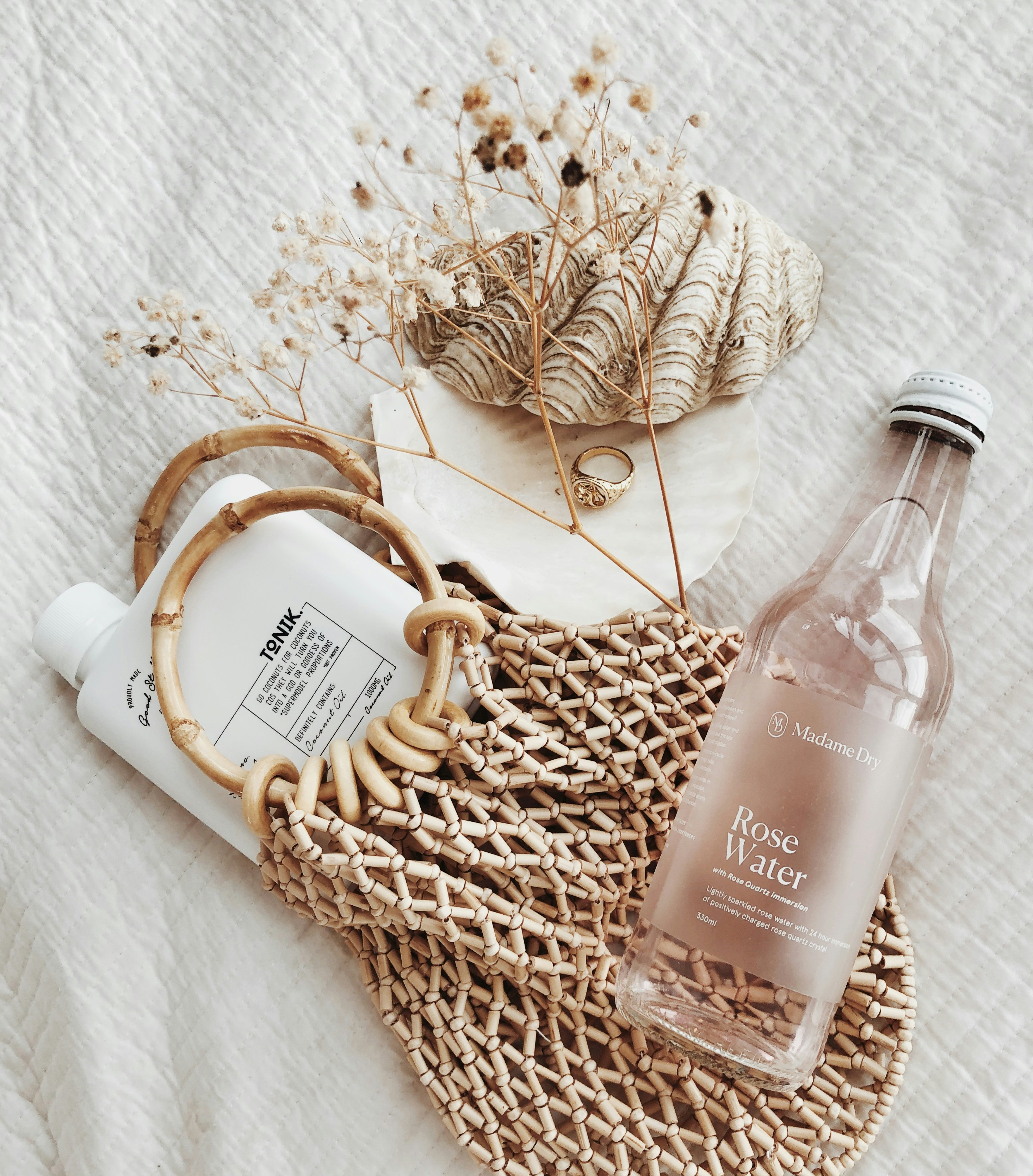 clear glass bottle on white textile
