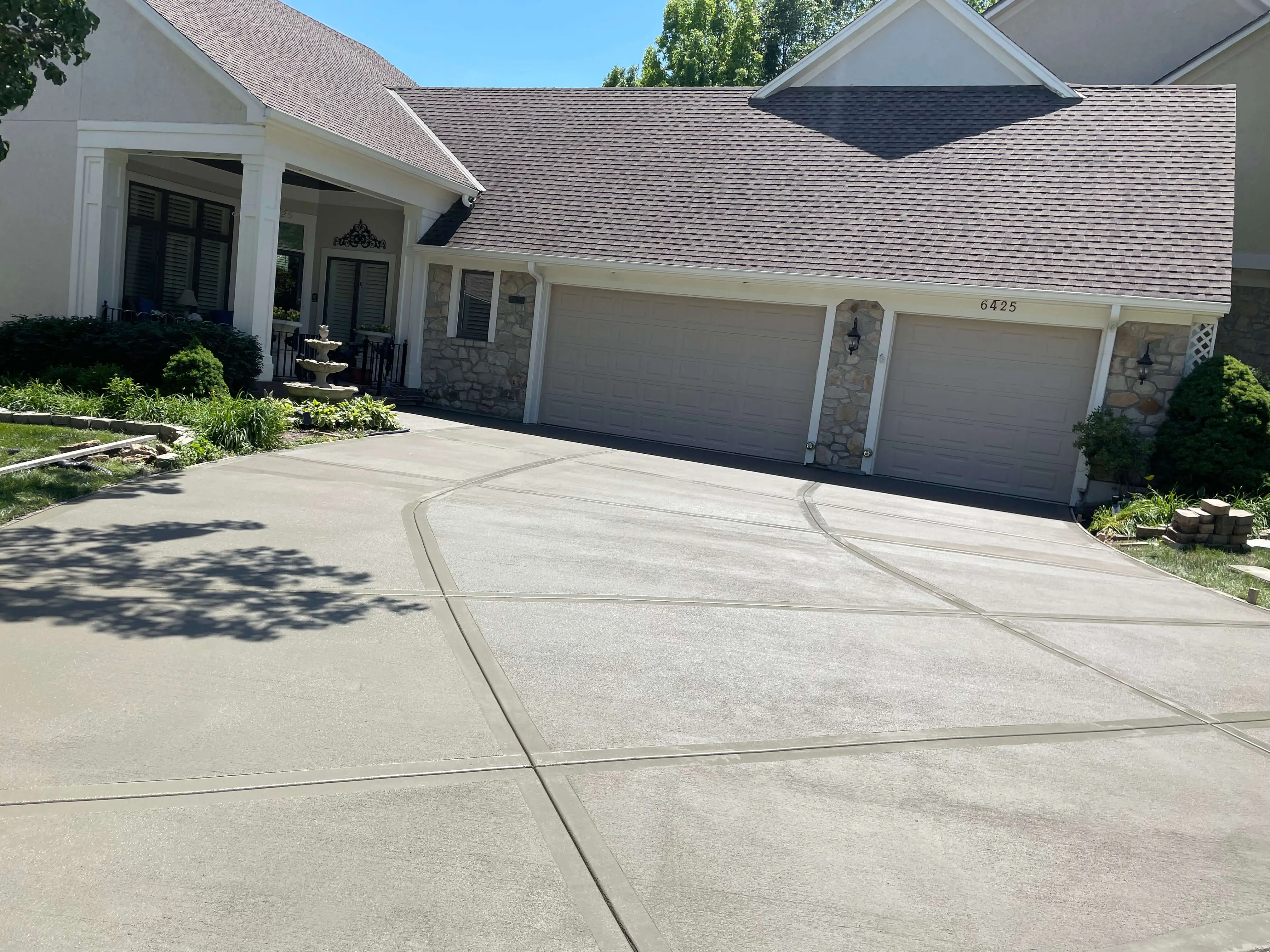 Concrete driveway project completed on a Kansas City home with a three car garage by Gladiator Home Improvement