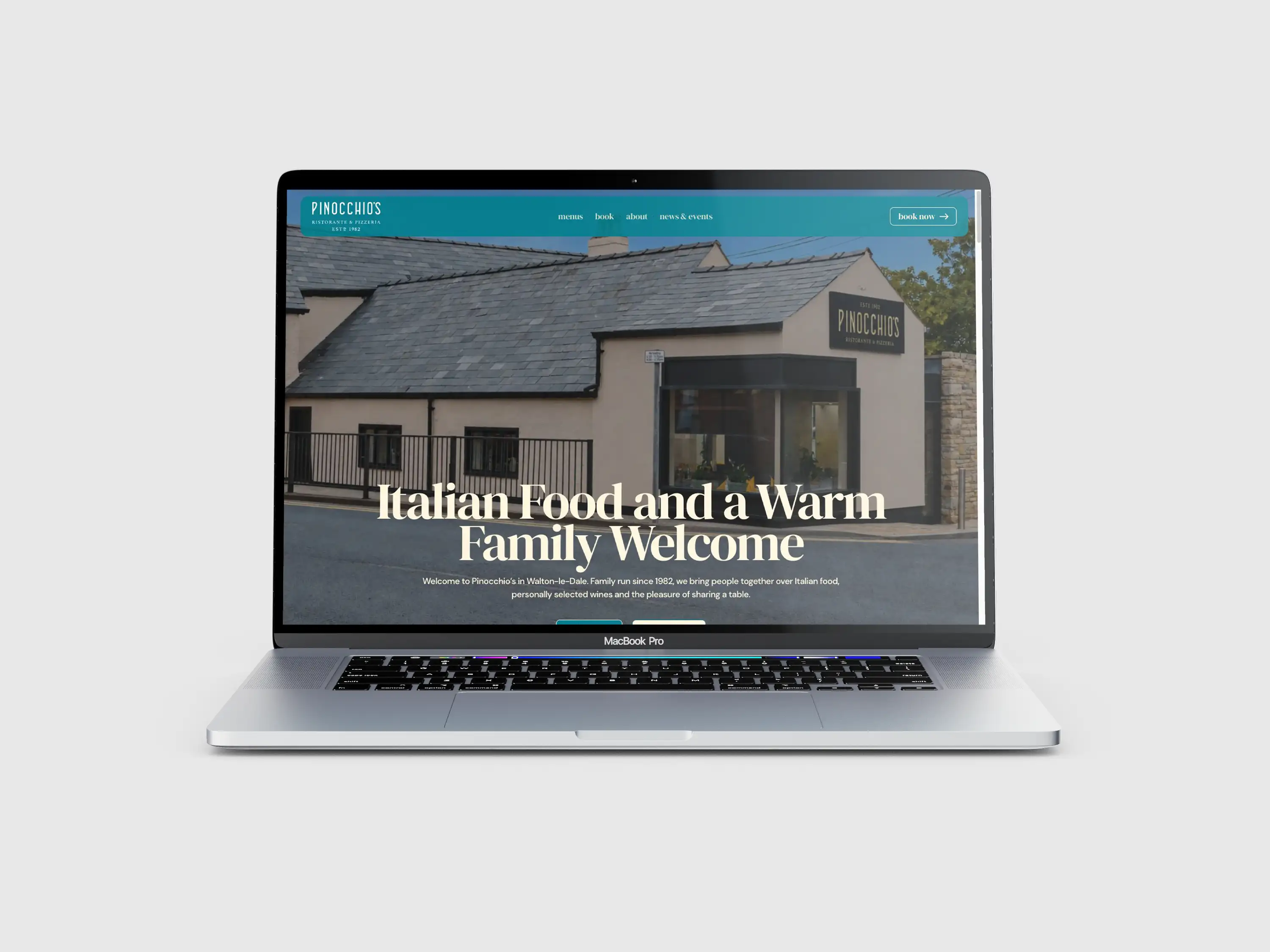 San Marco Group restaurant website displayed on a laptop, with blue navigation and an exterior photograph.