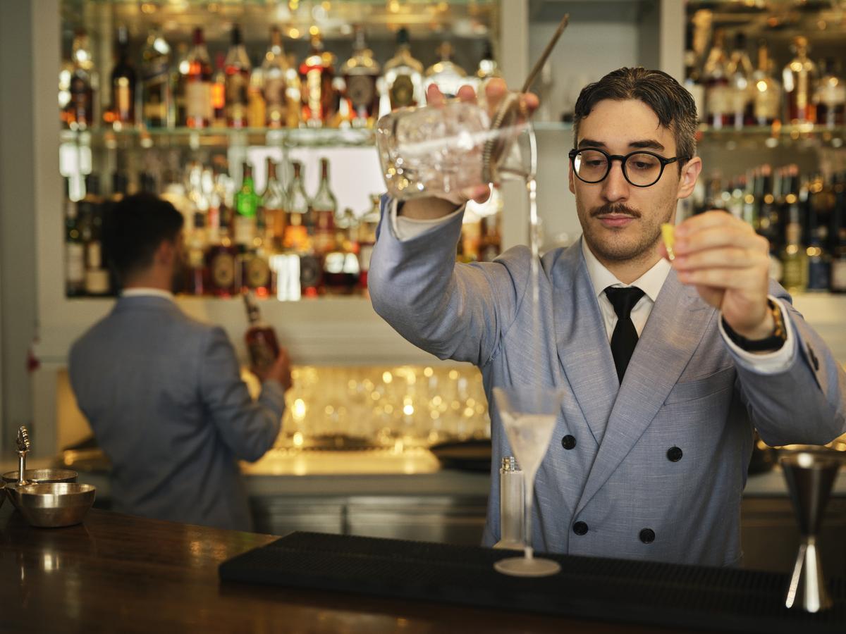 an orange sitting on top of a white bowl