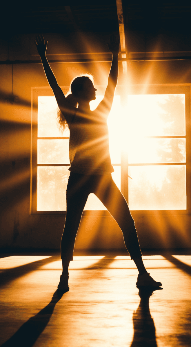 Woman doing yoga sunshine coming from window
