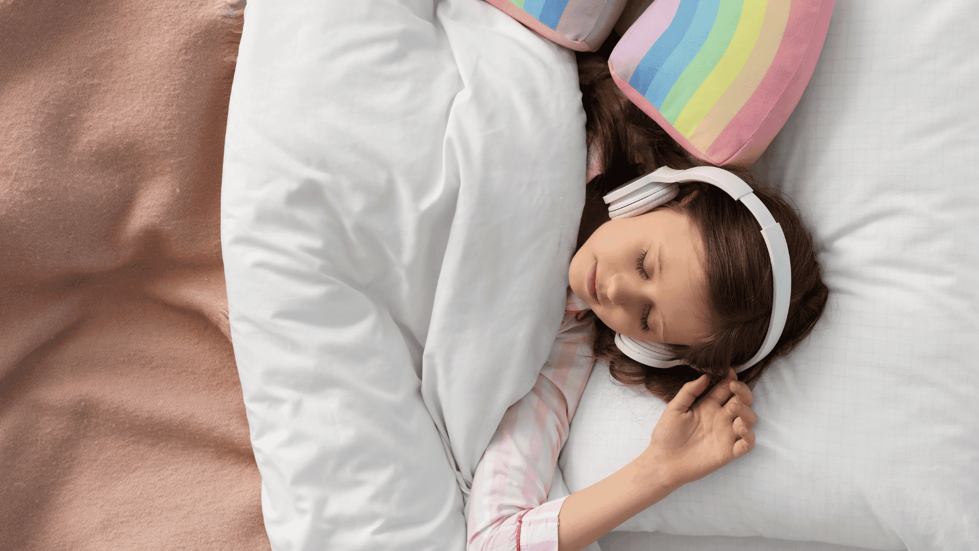 A girl tucked in bed, wearing headphones and falling asleep while listening to HushAway®’s Sound Sanctuary.