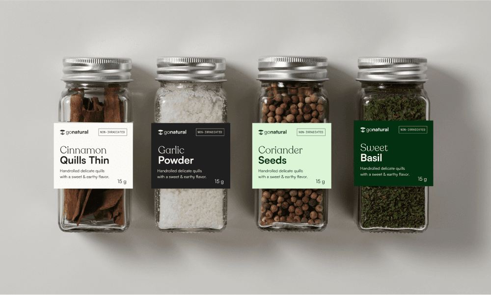 Four spice jars with labels on.